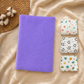 Purple dry mat beside three folded printed baby nappies